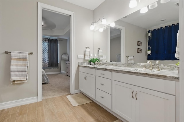 15963 Crofton Springs Way, Port Charlotte, FL 33953 - full bath with double vanity, wood finished floors, and baseboards
