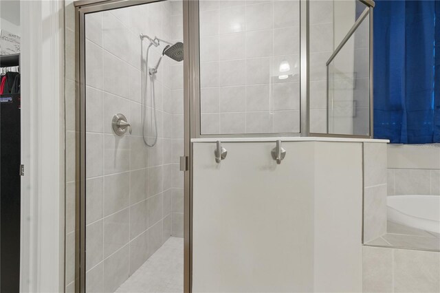15963 Crofton Springs Way, Port Charlotte, FL 33953 - bathroom featuring a shower stall, a bath, and a spacious closet