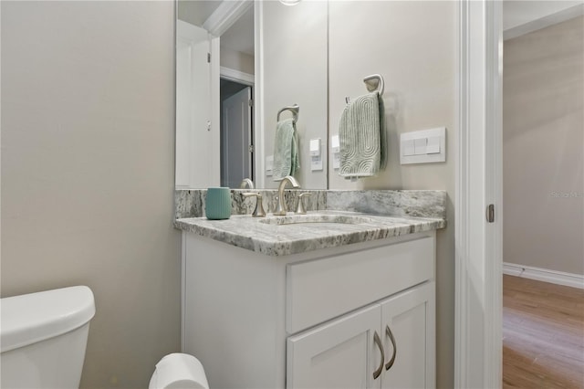 15963 Crofton Springs Way, Port Charlotte, FL 33953 - half bath featuring toilet, vanity, wood finished floors, and baseboards