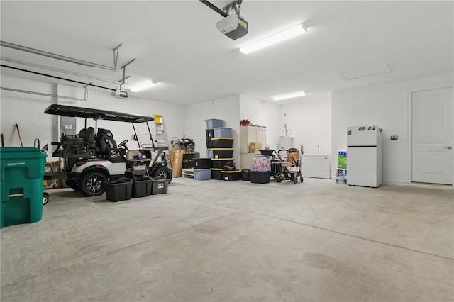 15963 Crofton Springs Way, Port Charlotte, FL 33953 - garage featuring freestanding refrigerator and a garage door opener