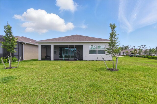 15963 Crofton Springs Way, Port Charlotte, FL 33953 - rear view of property featuring a sunroom, a yard, and stucco siding