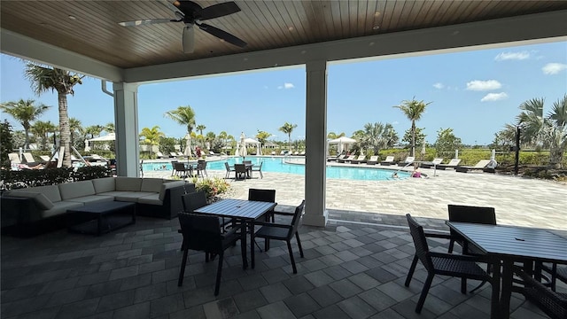 15963 Crofton Springs Way, Port Charlotte, FL 33953 - view of patio featuring outdoor dining space, ceiling fan, a community pool, and an outdoor hangout area