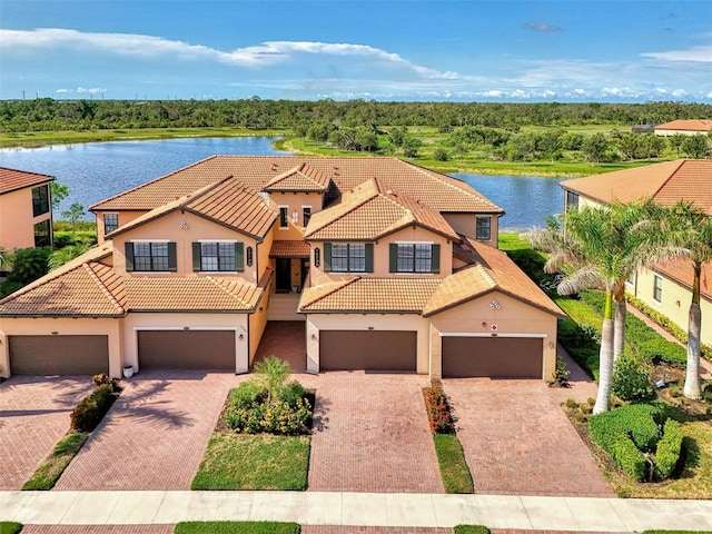10789 Tarflower Dr Unit 202, Venice, FL 34293 - view of front of home with stucco siding, a tiled roof, a water view, and driveway