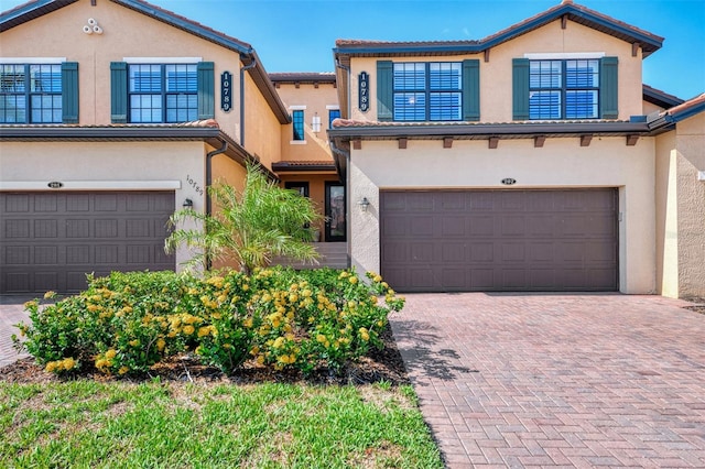10789 Tarflower Dr Unit 202, Venice, FL 34293 - mediterranean / spanish-style house with an attached garage and stucco siding