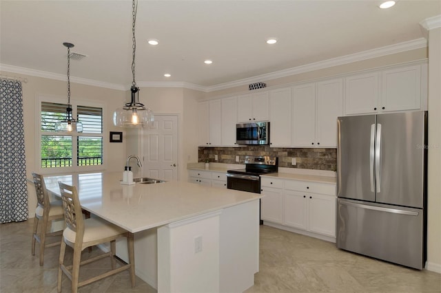 10789 Tarflower Dr Unit 202, Venice, FL 34293 - kitchen with appliances with stainless steel finishes, white cabinetry, crown molding, a kitchen island with sink, and light countertops