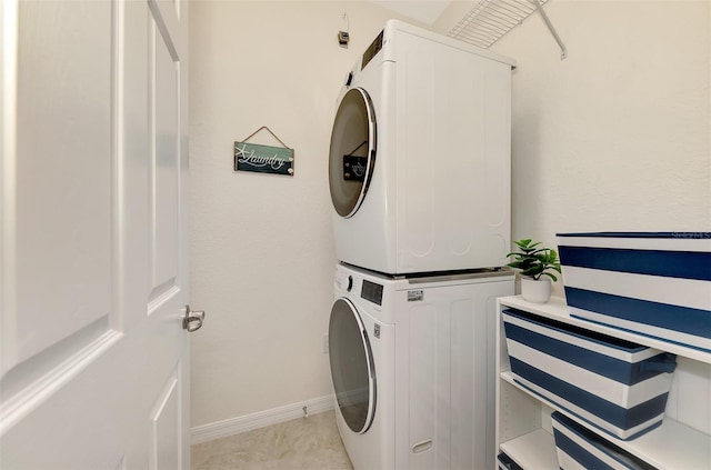 10789 Tarflower Dr Unit 202, Venice, FL 34293 - washroom with stacked washing machine and dryer and baseboards
