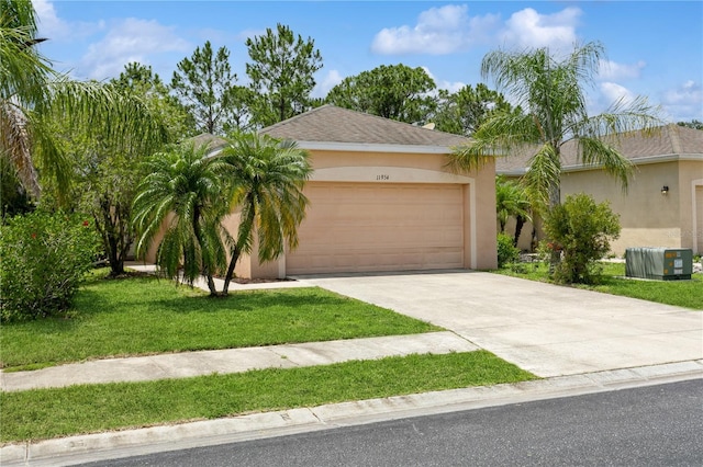 11954 Tempest Harbor Loop, Venice, FL 34292 - view of front of property with stucco siding, a garage, driveway, and a front lawn