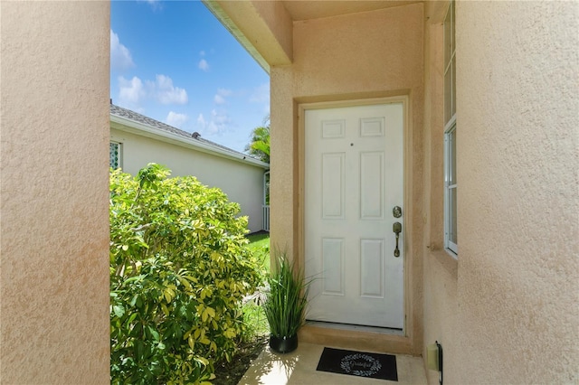 11954 Tempest Harbor Loop, Venice, FL 34292 - doorway to property with stucco siding