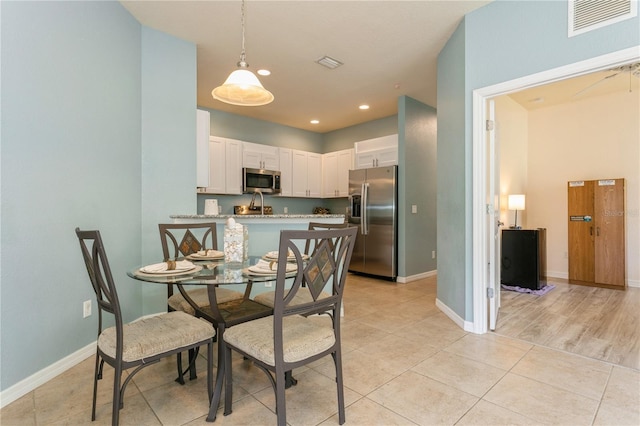 11954 Tempest Harbor Loop, Venice, FL 34292 - dining area with light tile patterned floors and recessed lighting