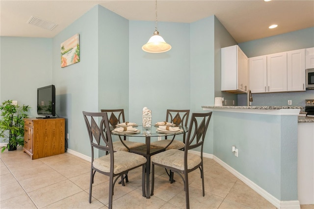 11954 Tempest Harbor Loop, Venice, FL 34292 - dining room with light tile patterned floors and recessed lighting