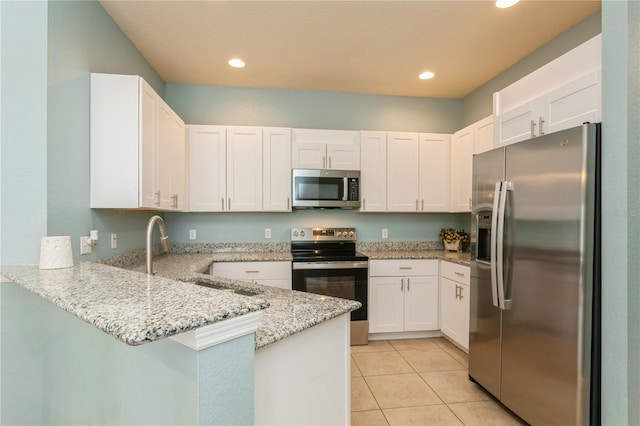 11954 Tempest Harbor Loop, Venice, FL 34292 - kitchen featuring stainless steel appliances, a peninsula, light stone countertops, white cabinetry, and light tile patterned floors