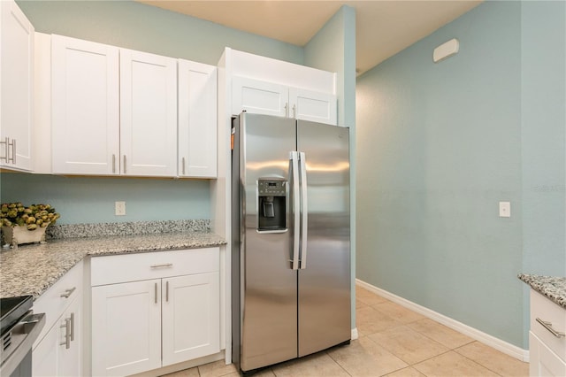 11954 Tempest Harbor Loop, Venice, FL 34292 - kitchen featuring appliances with stainless steel finishes, white cabinets, light tile patterned floors, and light stone counters