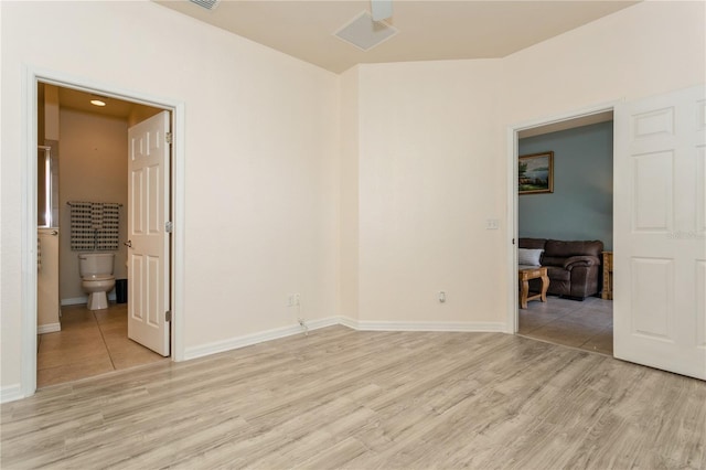 11954 Tempest Harbor Loop, Venice, FL 34292 - unfurnished bedroom with light wood finished floors and connected bathroom