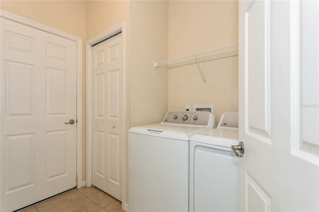 11954 Tempest Harbor Loop, Venice, FL 34292 - laundry area with separate washer and dryer and light tile patterned floors