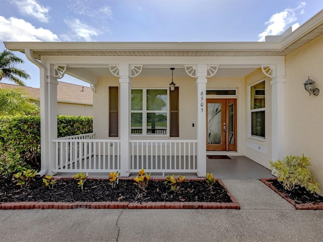 6505 Meandering Way, Lakewood Ranch, FL 34202 - property entrance with a porch and stucco siding