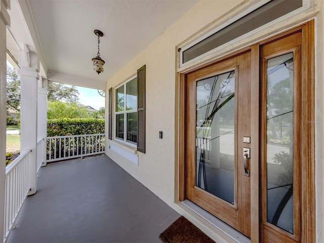 6505 Meandering Way, Lakewood Ranch, FL 34202 - doorway to property with a porch and stucco siding