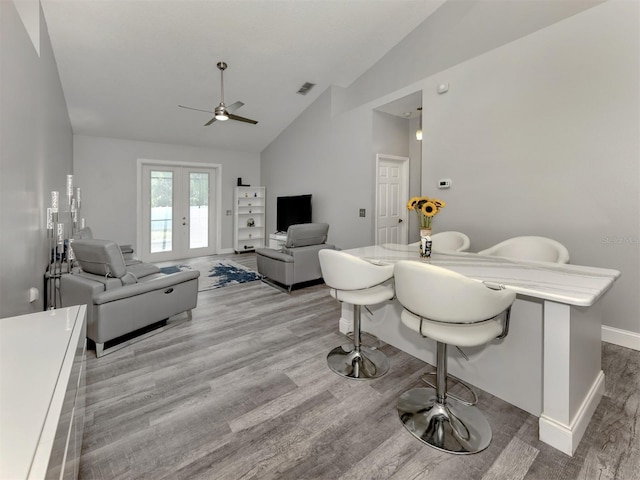 6505 Meandering Way, Lakewood Ranch, FL 34202 - living room featuring ceiling fan, wood finished floors, and high vaulted ceiling