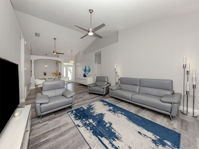 6505 Meandering Way, Lakewood Ranch, FL 34202 - living area featuring a ceiling fan, wood finished floors, vaulted ceiling, and arched walkways