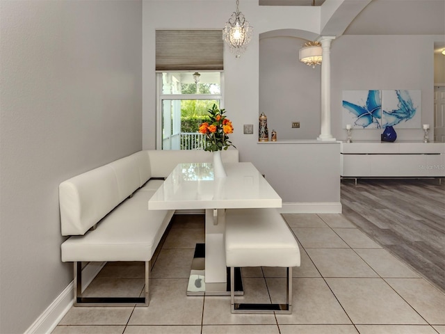 6505 Meandering Way, Lakewood Ranch, FL 34202 - tiled dining room with decorative columns and baseboards