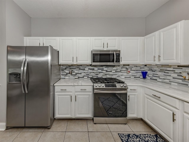 6505 Meandering Way, Lakewood Ranch, FL 34202 - kitchen featuring stainless steel appliances, white cabinets, and tasteful backsplash