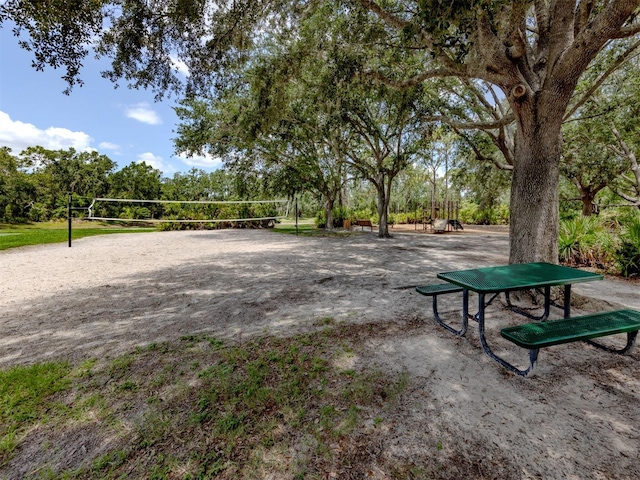 6505 Meandering Way, Lakewood Ranch, FL 34202 - view of community featuring volleyball court and view of wooded area