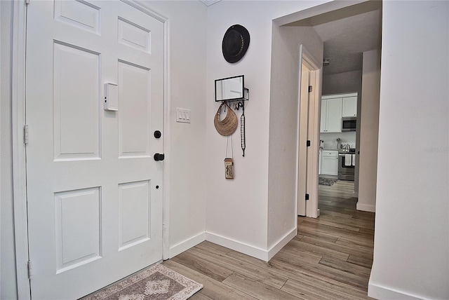 3340 Webber St, Sarasota, FL 34239 - foyer with baseboards and light wood-type flooring