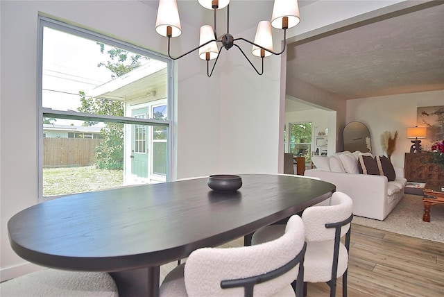 3340 Webber St, Sarasota, FL 34239 - dining space with a chandelier and wood finished floors