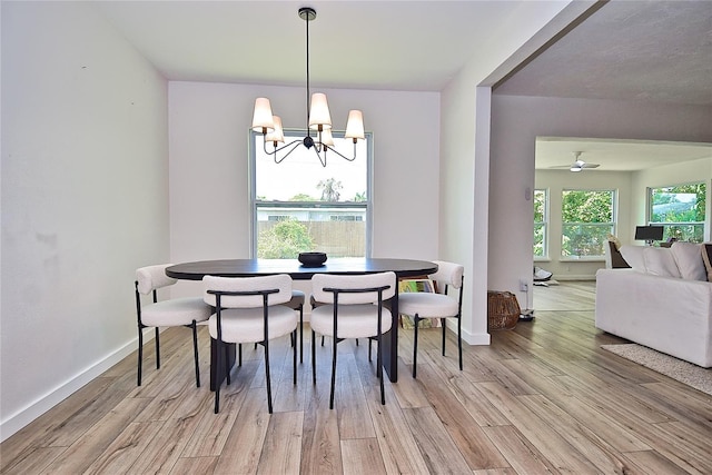 3340 Webber St, Sarasota, FL 34239 - dining room featuring a chandelier, light wood finished floors, and baseboards