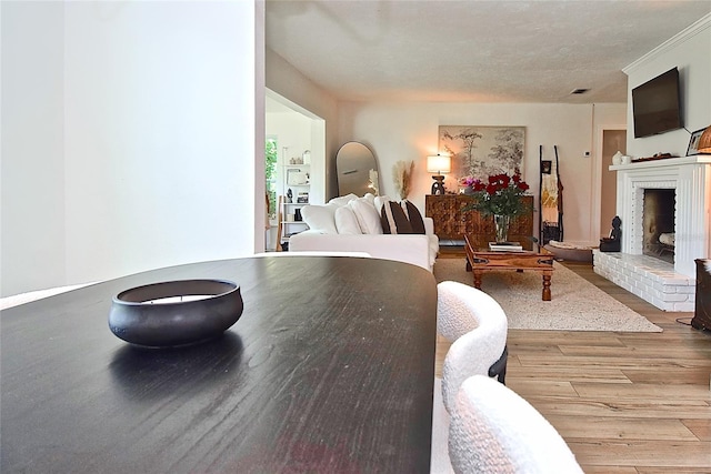 3340 Webber St, Sarasota, FL 34239 - dining space featuring wood finished floors and a brick fireplace