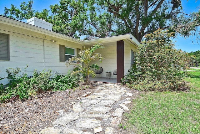 3340 Webber St, Sarasota, FL 34239 - view of side of property with a chimney and a patio area