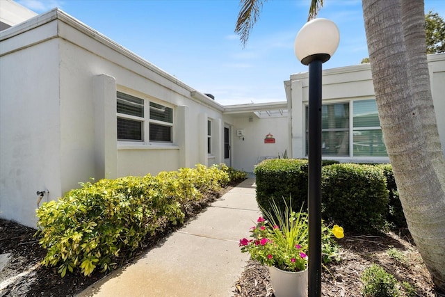 751 Capri Isles Blvd Unit 108, Venice, FL 34292 - doorway to property with stucco siding