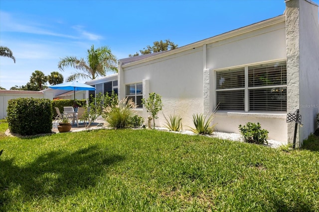 751 Capri Isles Blvd Unit 108, Venice, FL 34292 - view of green lawn with a patio area