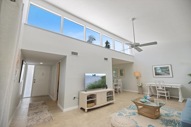 751 Capri Isles Blvd Unit 108, Venice, FL 34292 - living area featuring a towering ceiling, ceiling fan, and baseboards
