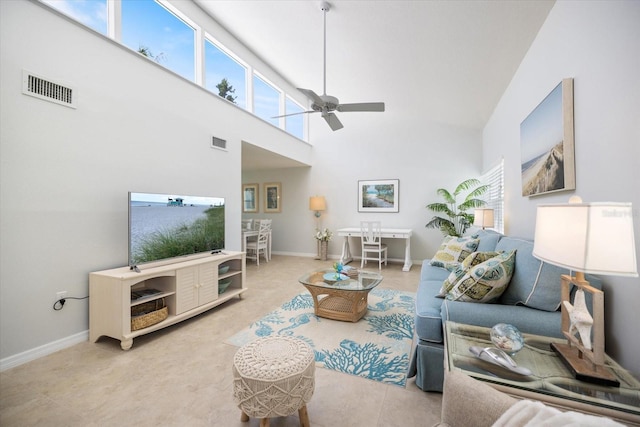 751 Capri Isles Blvd Unit 108, Venice, FL 34292 - living area featuring ceiling fan, a towering ceiling, and baseboards