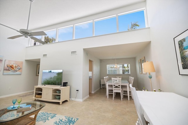 751 Capri Isles Blvd Unit 108, Venice, FL 34292 - living area with a chandelier, a towering ceiling, baseboards, and ceiling fan