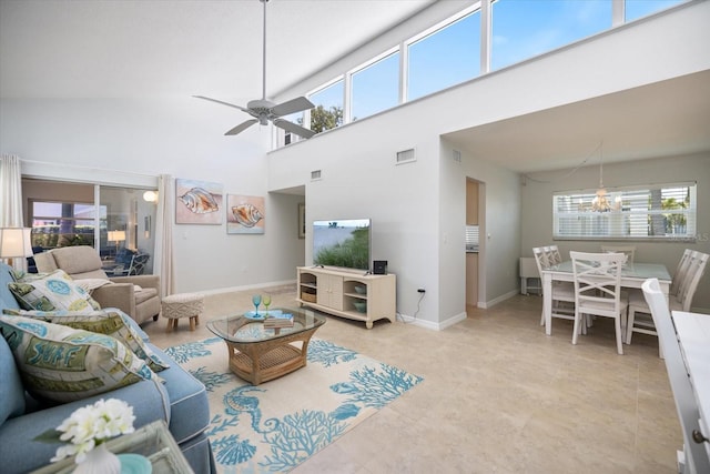 751 Capri Isles Blvd Unit 108, Venice, FL 34292 - living room with ceiling fan, a chandelier, a towering ceiling, and baseboards