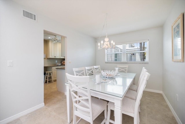 751 Capri Isles Blvd Unit 108, Venice, FL 34292 - dining area featuring a chandelier, light tile patterned flooring, and baseboards