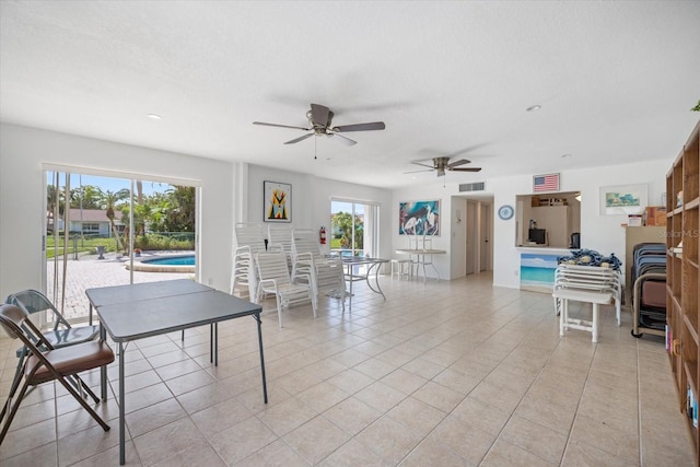 751 Capri Isles Blvd Unit 108, Venice, FL 34292 - game room with a ceiling fan, light tile patterned floors, recessed lighting, and a fireplace