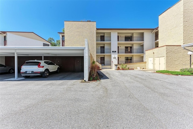 2718 Orchid Oaks Dr Unit C-202, Sarasota, FL 34239 - view of building exterior featuring covered parking