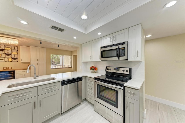 2718 Orchid Oaks Dr Unit C-202, Sarasota, FL 34239 - kitchen featuring stainless steel appliances, recessed lighting, light countertops, gray cabinetry, and wine cooler