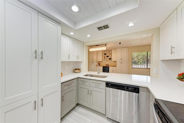 2718 Orchid Oaks Dr Unit C-202, Sarasota, FL 34239 - kitchen featuring stainless steel dishwasher, recessed lighting, decorative backsplash, light countertops, and gray cabinets