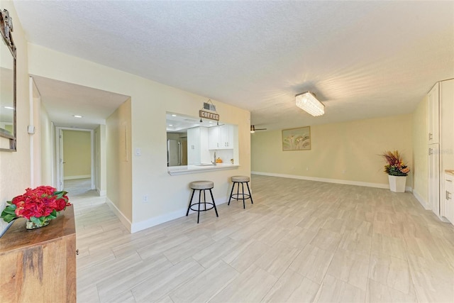 2718 Orchid Oaks Dr Unit C-202, Sarasota, FL 34239 - living area featuring light wood-style floors and a textured ceiling