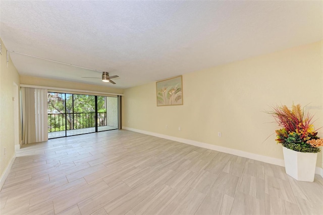 2718 Orchid Oaks Dr Unit C-202, Sarasota, FL 34239 - unfurnished room featuring ceiling fan, light wood-style floors, and a textured ceiling