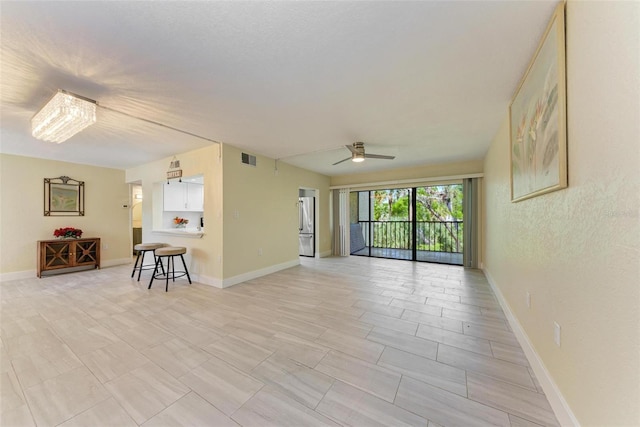 2718 Orchid Oaks Dr Unit C-202, Sarasota, FL 34239 - unfurnished living room with a ceiling fan and baseboards