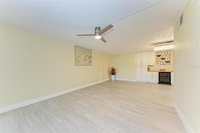 2718 Orchid Oaks Dr Unit C-202, Sarasota, FL 34239 - unfurnished room with beverage cooler and a ceiling fan