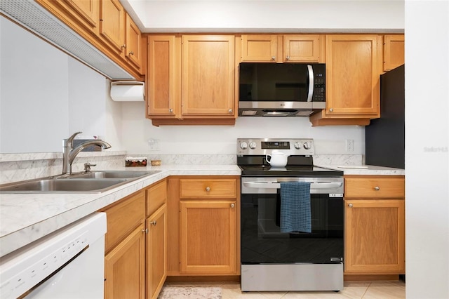 849 Wexford Blvd Unit 849, Venice, FL 34293 - kitchen with stainless steel appliances, light countertops, and light tile patterned floors