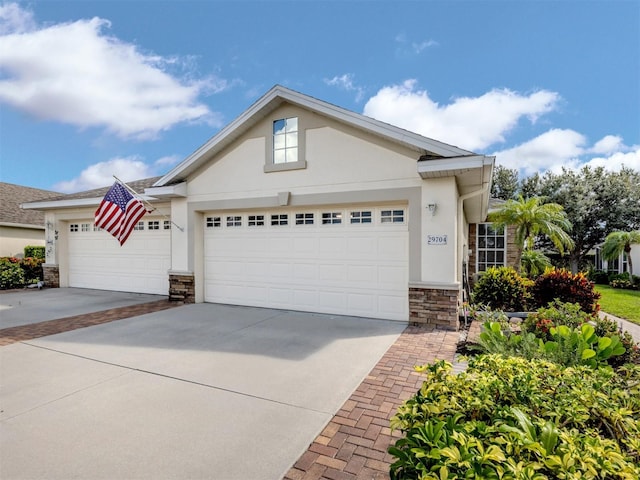 29704 Niagara Ct, Englewood, FL 34223 - view of front of house with stucco siding, an attached garage, concrete driveway, and stone siding