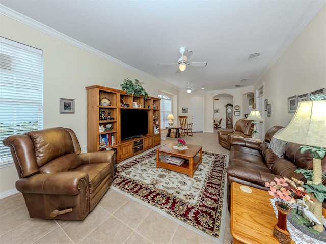 29704 Niagara Ct, Englewood, FL 34223 - living area featuring a ceiling fan, light tile patterned flooring, ornamental molding, and arched walkways