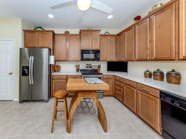 29704 Niagara Ct, Englewood, FL 34223 - kitchen featuring black appliances, brown cabinets, a ceiling fan, light tile patterned floors, and recessed lighting