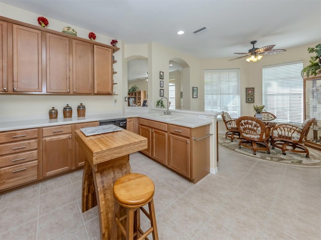 29704 Niagara Ct, Englewood, FL 34223 - kitchen featuring ceiling fan, a peninsula, arched walkways, light tile patterned floors, and recessed lighting